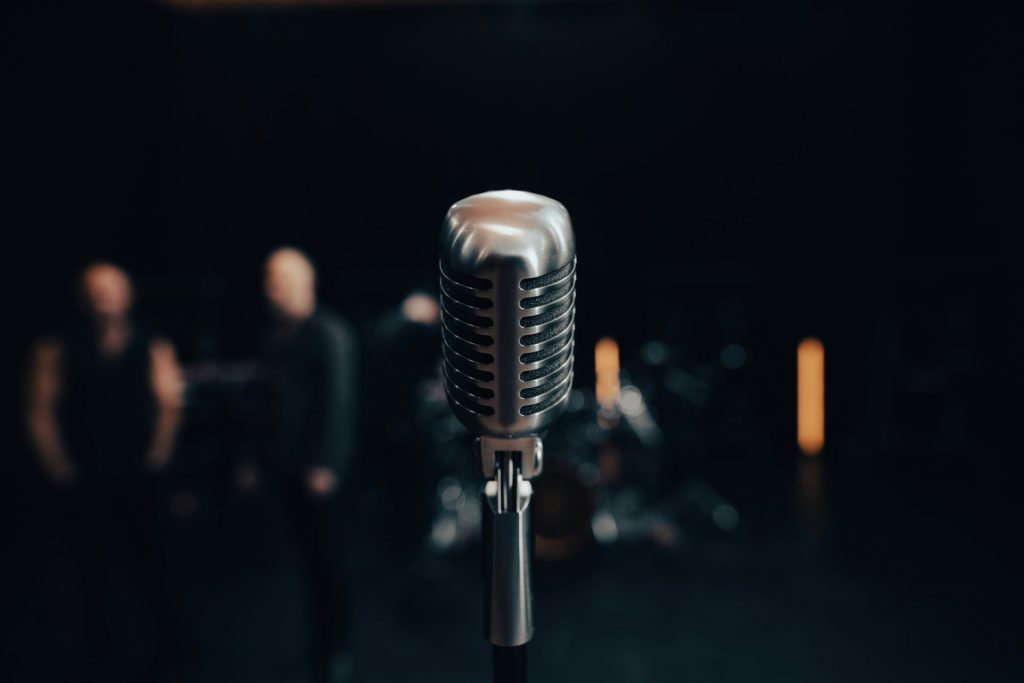 a microphone with a band in the background